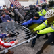 In this Jan. 6, 2021, file photo violent insurrectionists loyal to President Donald Trump hold on to a police barrier at the Capitol in Washington.